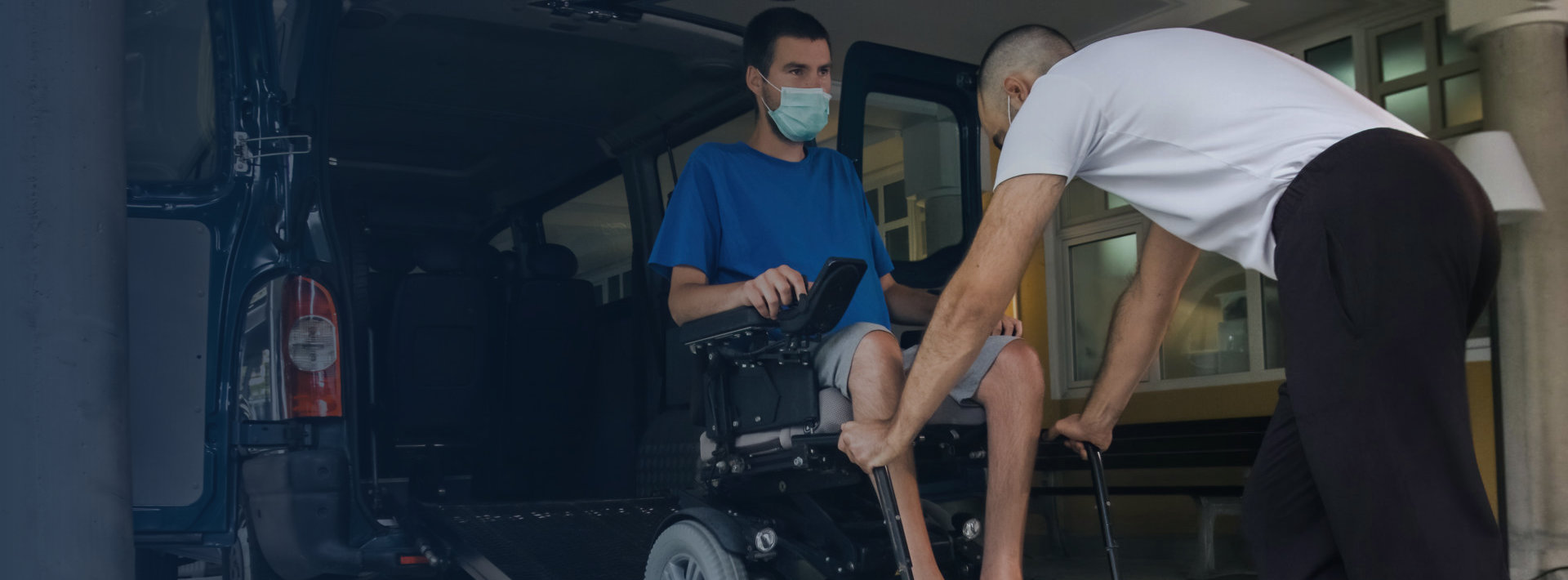 disabled man being assisted into the transportation vehicle