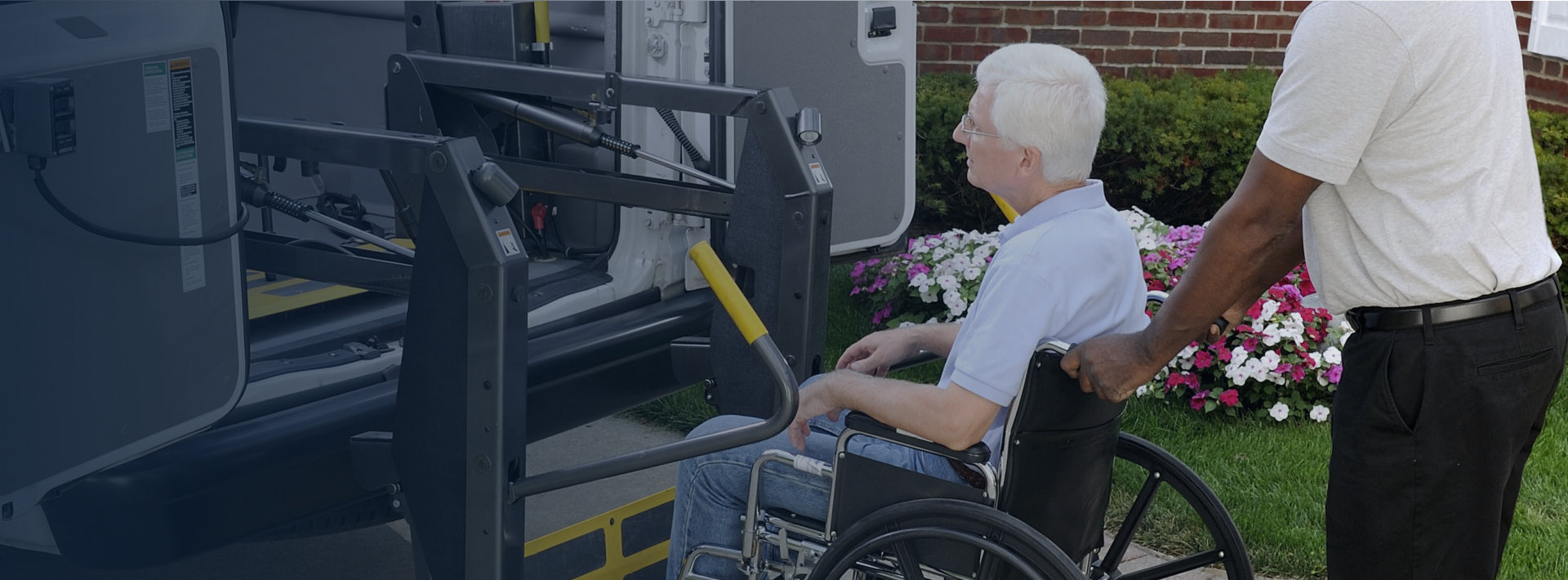 representative is loading a wheel chair customer into a transportation vehicle