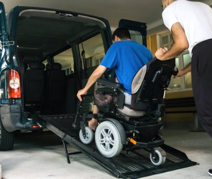 man on wheelchair using accessible vehicle with ramp